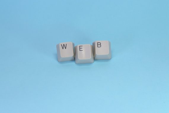 Keyboard keys spelling web on blue background representing WordPress permalink and URL structure